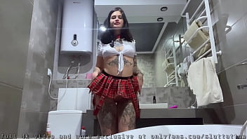 Schoolgirl plays with herself with a vibrator in the bathroom